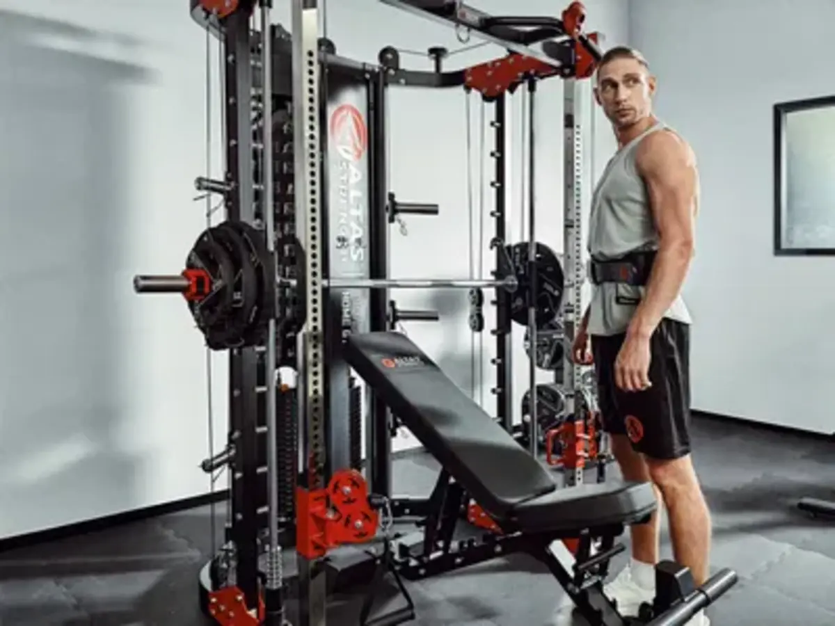 Man beside an Atlas Strength weightlifting bench setup